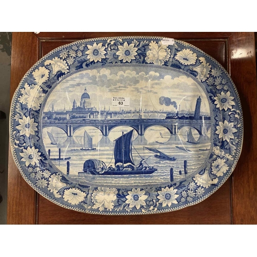 63 - Ceramics: 19th century blue and white meat plate depicting a stylised scene of St. Pauls and The Tha... 
