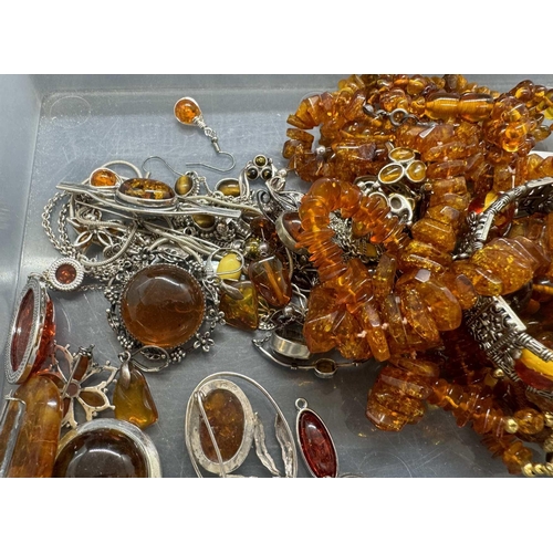 722 - Jewellery: Hallmarked silver and white metal mainly set with amber, three amber necklets and bracele... 