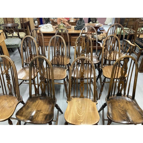 77 - Early 20th cent. Harlequin set of twelve aesthetic Windsor chairs, seven plus two carvers. Beech wit... 