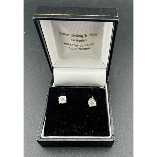 814 - Pair of 18ct gold earrings each set with a brilliant cut diamond, estimated weight of (2) o.60ct, ha... 