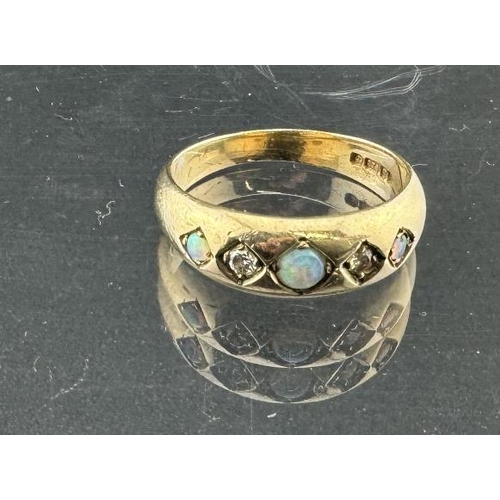 816 - Jewellery: A 9ct gold ring, London 1976, claw set with three opals divided by diamonds. UK size O, 3... 