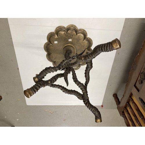 88 - Furniture: A 19th Century brass topped antler horn occasional table. 52cms high.