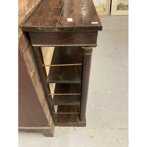 97 - Furniture: Regency rosewood dwarf bookcase with column supports, with faults.