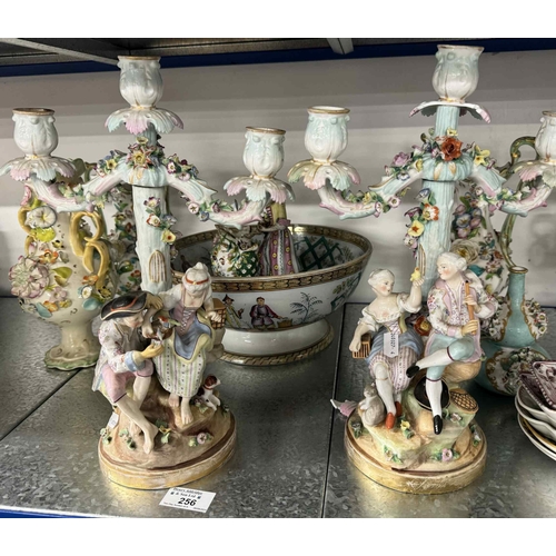 256 - Ceramics: Ceramics: A pair of Continental three-stick candelabra, each modelled as a courting couple... 