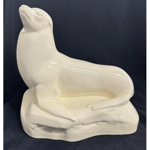 257 - Ceramics: Ceramics: A John Skeaping for Wedgwood white glazed seal, c.1935, depicted laying on a roc... 