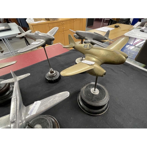 311 - Militaria: Militaria: Four mid 20th century brass aeroplanes, largest 24cm wingspan, together with s... 