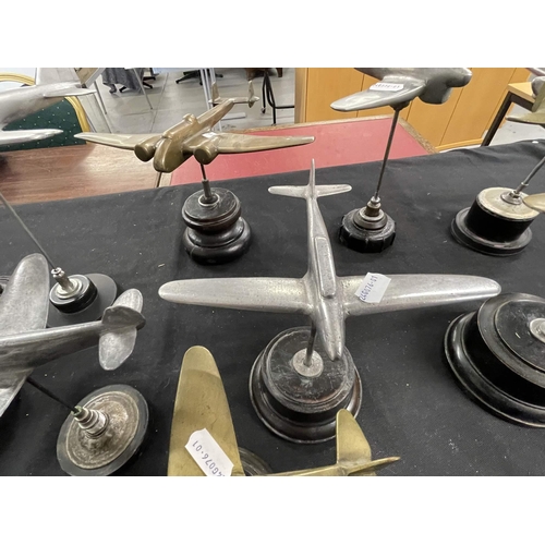 311 - Militaria: Militaria: Four mid 20th century brass aeroplanes, largest 24cm wingspan, together with s... 