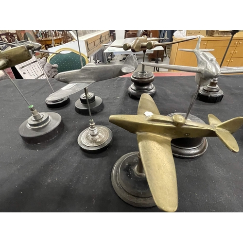 311 - Militaria: Militaria: Four mid 20th century brass aeroplanes, largest 24cm wingspan, together with s... 