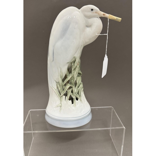 518 - Ceramics: Ceramics: A Royal Copenhagen model of a heron standing amongst reeds, number 068, 27cm, to... 