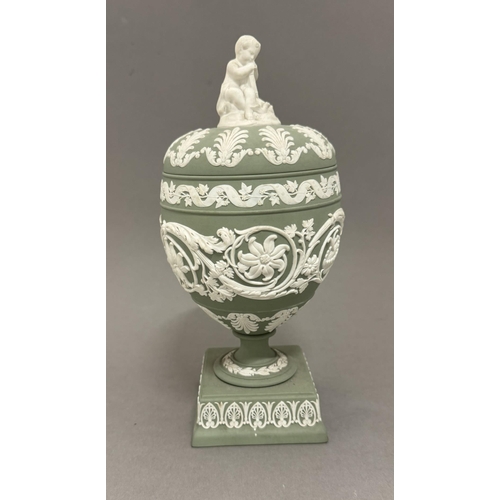 528a - Ceramiics: Ceramics: A 20th century sage green Wedgwood Jasperware urn, with square pedestal base an... 