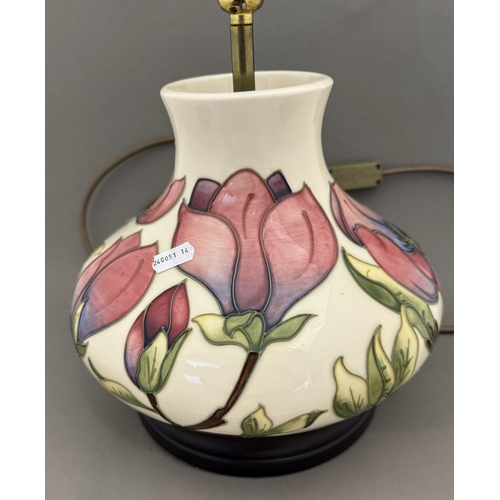 555 - Ceramics: Ceramics: A Moorcroft Pottery Magnolia pattern lamp of squat form, mounted upon a wooden p... 