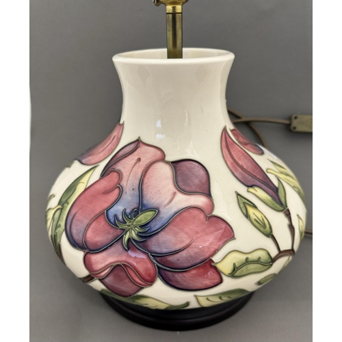 555 - Ceramics: Ceramics: A Moorcroft Pottery Magnolia pattern lamp of squat form, mounted upon a wooden p... 