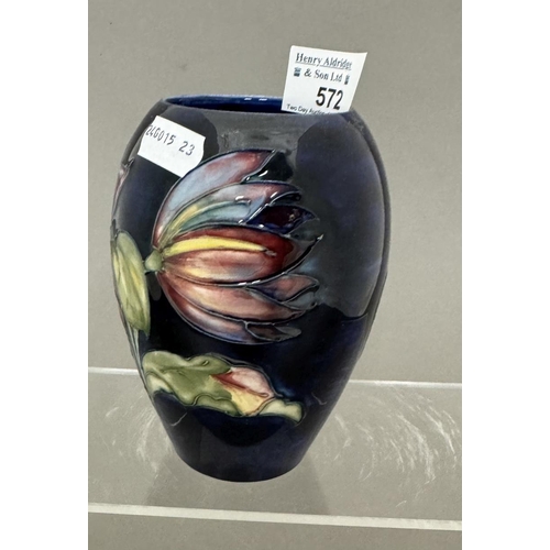 572 - Ceramics: Ceramics: A Moorcroft Pottery Clematis pattern on a dark blue ground ovoid vase, impressed... 