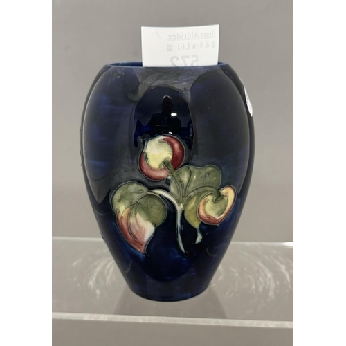 572 - Ceramics: Ceramics: A Moorcroft Pottery Clematis pattern on a dark blue ground ovoid vase, impressed... 