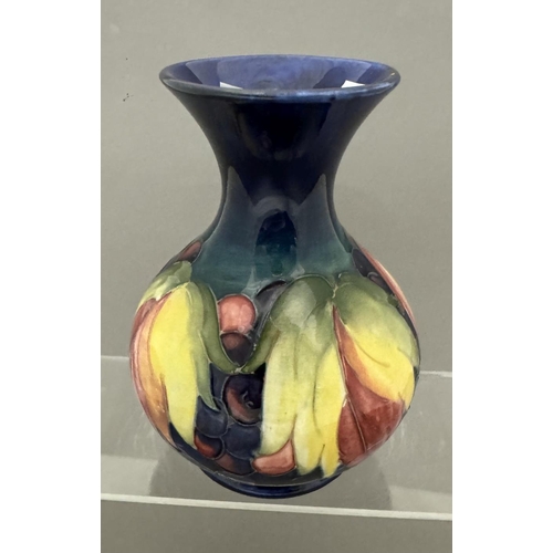 578 - Ceramics: Ceramics: A Moorcroft Pottery Leaf and Berry baluster vase with flared mouth, impressed ma... 