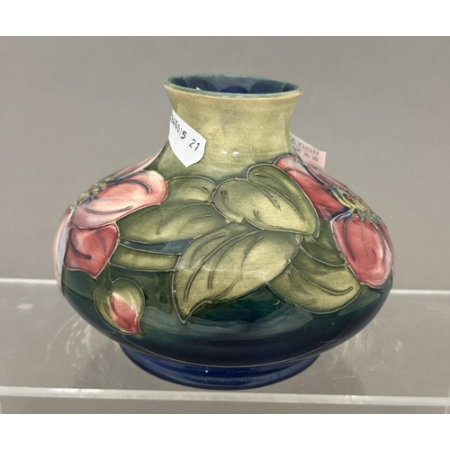 581 - Ceramics: Ceramics: A Moorcroft Pottery squat vase painted in the Clematis pattern to a green ground... 