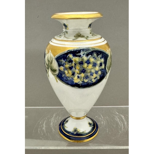 584 - Ceramics: Ceramics: William Moorcroft for Macintyre, a 'Lilac' Florian vase, of baluster form upon a... 