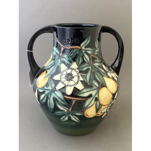 594 - Ceramics: Ceramics: A Moorcroft Pottery two handled amphora style vase, decorated with the 