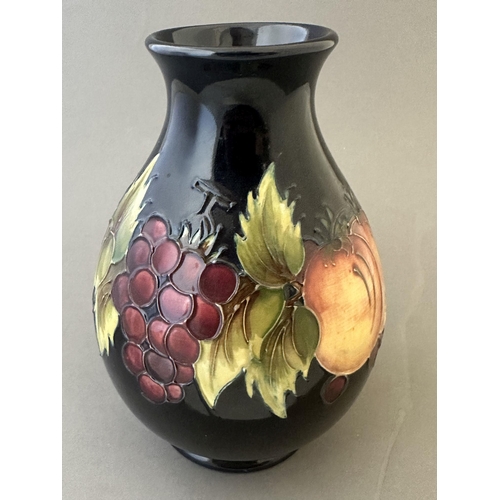 595 - Ceramics: Ceramics: A Moorcroft Pottery Fruit and Vine tube lined vase, impressed marks and painted ... 