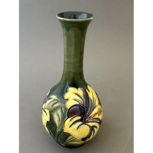 596 - Ceramics: Ceramics: A Moorcroft Pottery green ground Hibiscus pattern tube lined vase, stamped and s... 