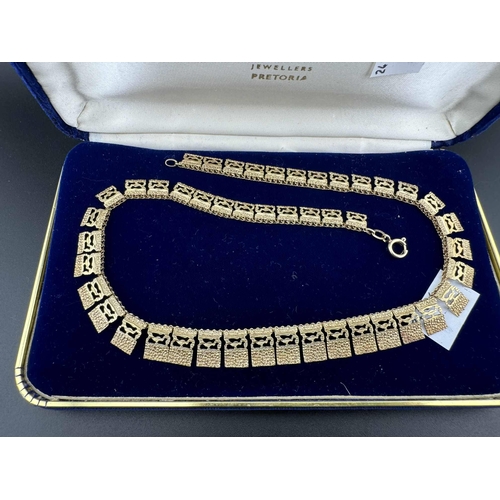 703 - Jewellery: Yellow metal Egyptian style necklace marked 9ct, with box. 22g. 42cm.