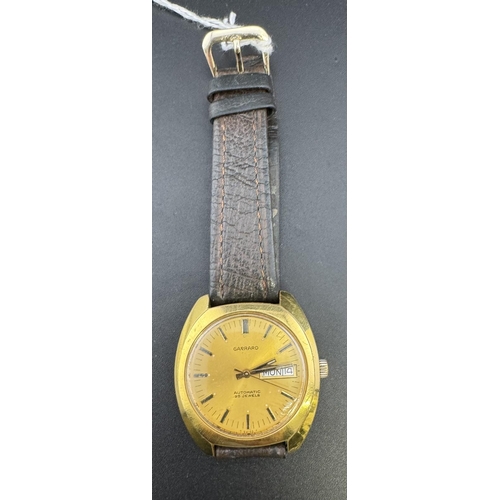 756 - Watches: 1970s/80 Garrard automatic watch, gold tone case and face on brown leather strap.... 