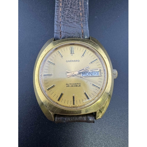 756 - Watches: 1970s/80 Garrard automatic watch, gold tone case and face on brown leather strap.... 