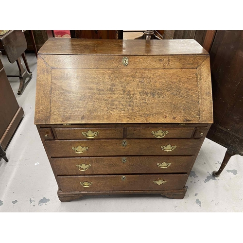 77 - Furniture: / Furniture: / Mirrors: Late 18th/early 19th Century oak bureau with well, secret drawers... 