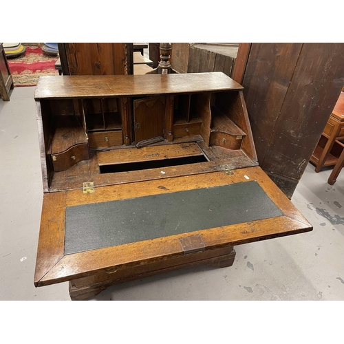 77 - Furniture: / Furniture: / Mirrors: Late 18th/early 19th Century oak bureau with well, secret drawers... 