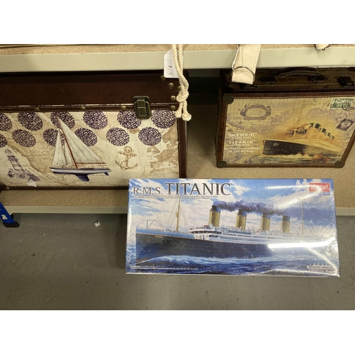 51 - Travel: Travel: A leather bound small cabin trunk decorated with a yacht impressed on an ocean chart... 