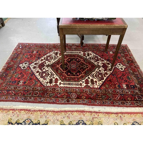 75 - Rug: Rug: Red ground rug with central geometric decoration142 x 235cm.