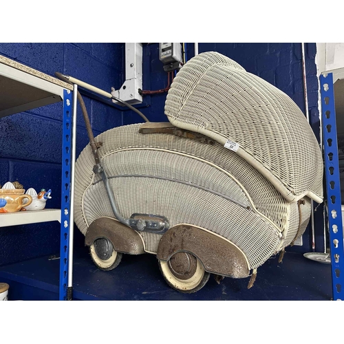 22 - 1930s Lloyd Loom style rattan pram in the style of a shell.