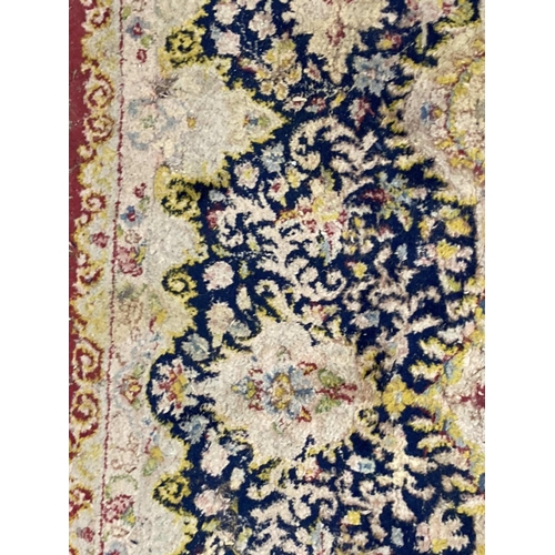 85 - Rugs & Carpets: Early 20th cent. British carpet, red ground with central floral motif and one la... 