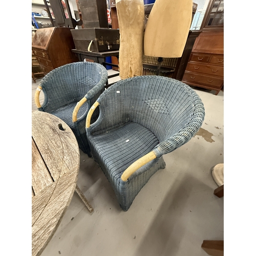 113 - Gardenalia: Gardenalia: Two Lloyd Loom style armchairs in blue with exposed beech handholds, the rat... 