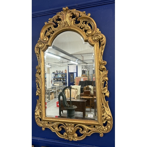 128 - Mirrors Mirrors: Arch top 20th century giltwood mirror in the 17th Century Rococo style, with bevell... 