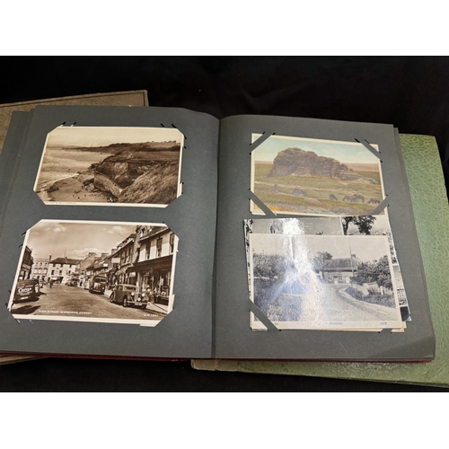 326 - Postcards Postcards: Postcards, four albums of Edwardian and later cards. The two larger contain Can... 