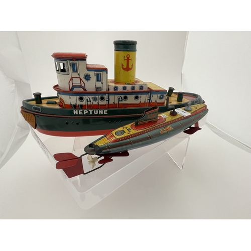 399 - Toys and Games Toys and Games: Barco, Japan, Tinplate battery powered wheeled tugboat, a meltoy temp... 