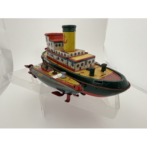 399 - Toys and Games Toys and Games: Barco, Japan, Tinplate battery powered wheeled tugboat, a meltoy temp... 