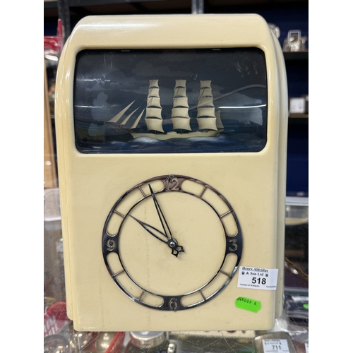 518 - Clocks: Clocks: A WHITE BAKELITE ELECTRIC CLOCK WITH ROCKING SHIP AUTOMATON Vitascope, No.05631, 194... 