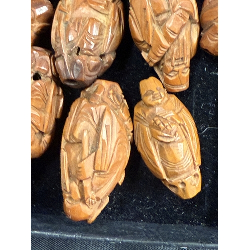 538 - Oriental: Oriental: A collection of twelve Chinese heidao carved nuts, each depicting a sage or scho... 