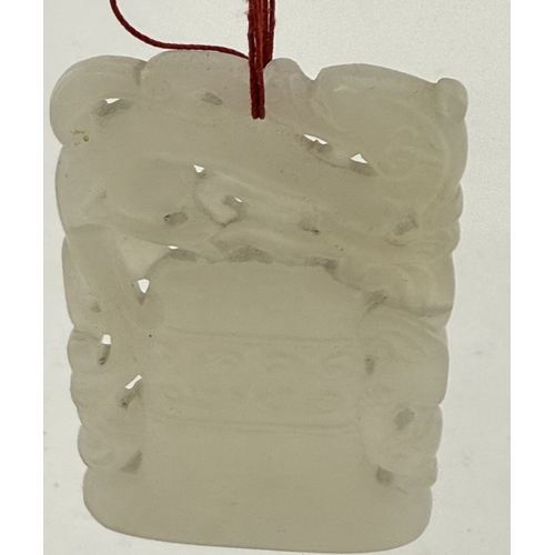 542 - Oriental: Oriental: A Chinese carved white or pale celadon jade plaque carved as a temple bell with ... 