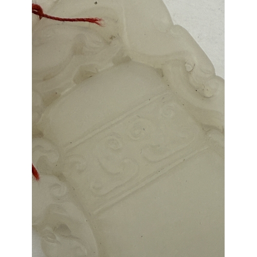 542 - Oriental: Oriental: A Chinese carved white or pale celadon jade plaque carved as a temple bell with ... 