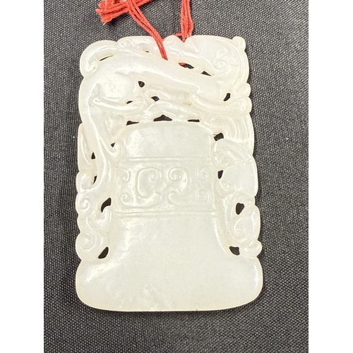 542 - Oriental: Oriental: A Chinese carved white or pale celadon jade plaque carved as a temple bell with ... 