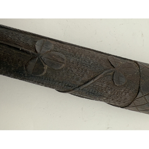 553 - Treen: Treen: A 19th century Irish carved oak Parish constables truncheon, carved all over in typica... 