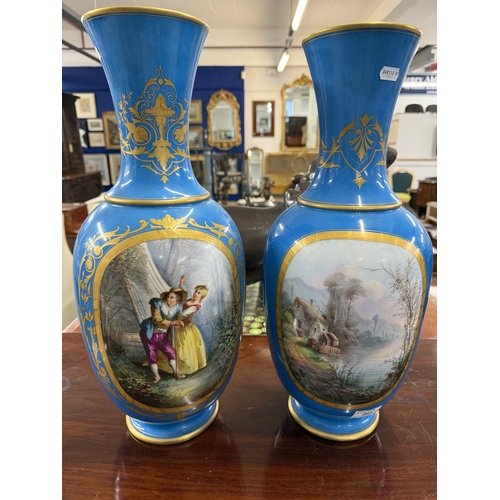 560 - Ceramics: Ceramics: A pair of 19th century French blue ground baluster vases, each painted with a la... 