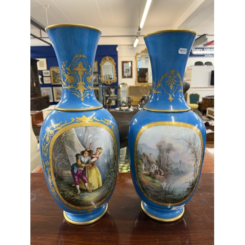 560 - Ceramics: Ceramics: A pair of 19th century French blue ground baluster vases, each painted with a la... 