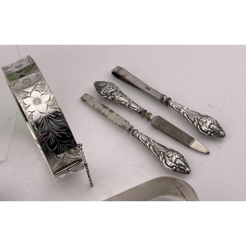 596 - Silver: Silver: A silver handled tortoiseshell letter opener, Birmingham 1888; a pair of silver suga... 