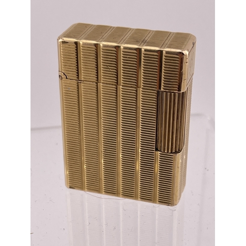 609 - Smoking Requisites: Smoking Requisites: An ST Dupont Ligne 1 gold plated lighter, with associated bl... 