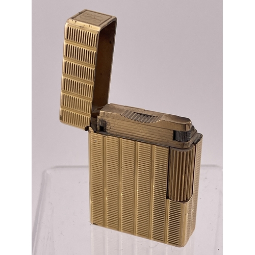 609 - Smoking Requisites: Smoking Requisites: An ST Dupont Ligne 1 gold plated lighter, with associated bl... 