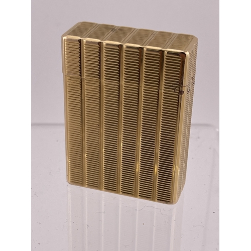 609 - Smoking Requisites: Smoking Requisites: An ST Dupont Ligne 1 gold plated lighter, with associated bl... 